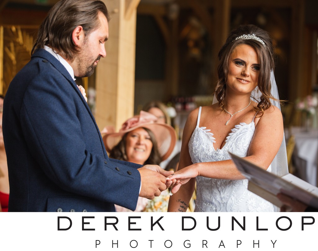 candid moment with couple exchanging rings