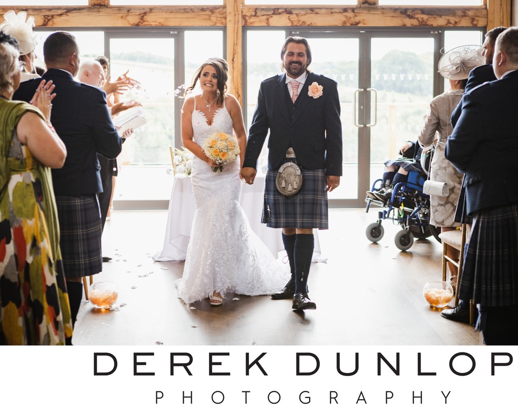 walking down the aisle with bride and groom