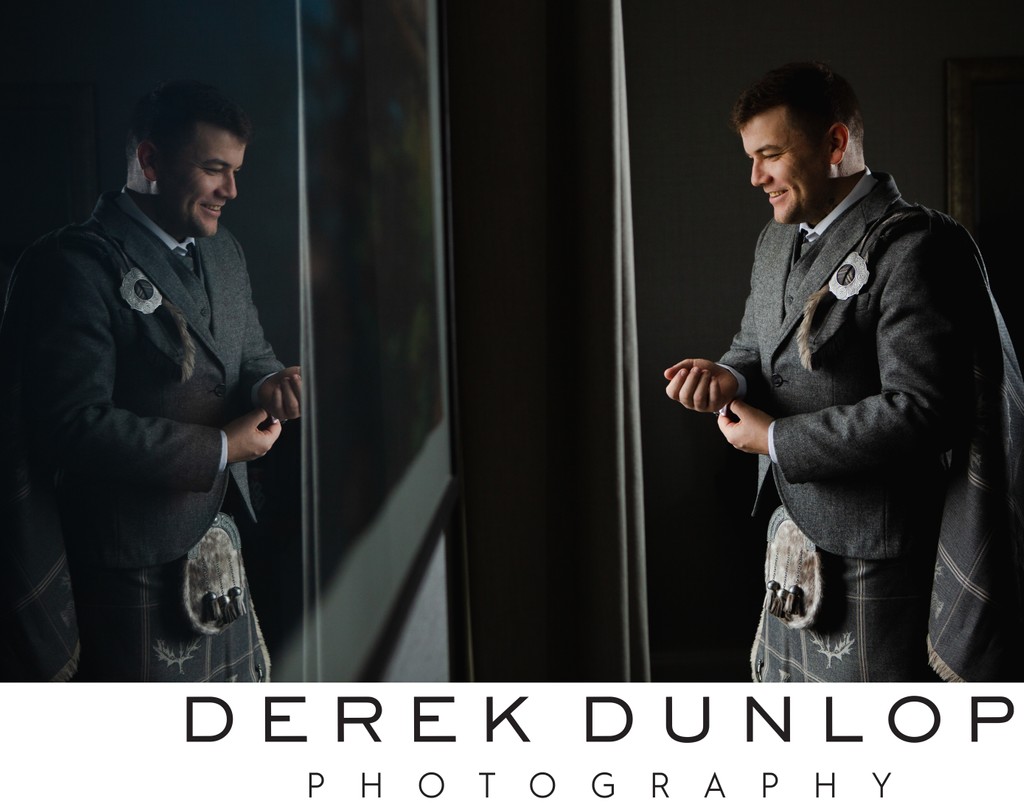 Dark and moody groom portrait at wedding in The Marine