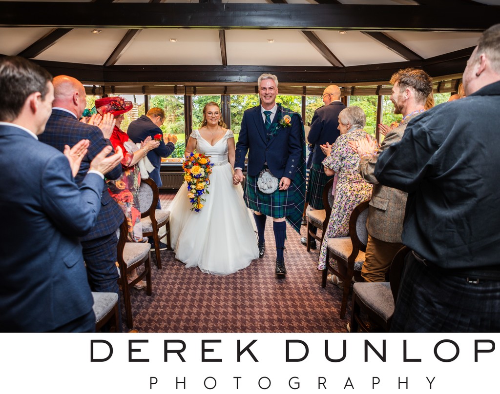 newly married walking down the aisle at Ayrshire wedding venue