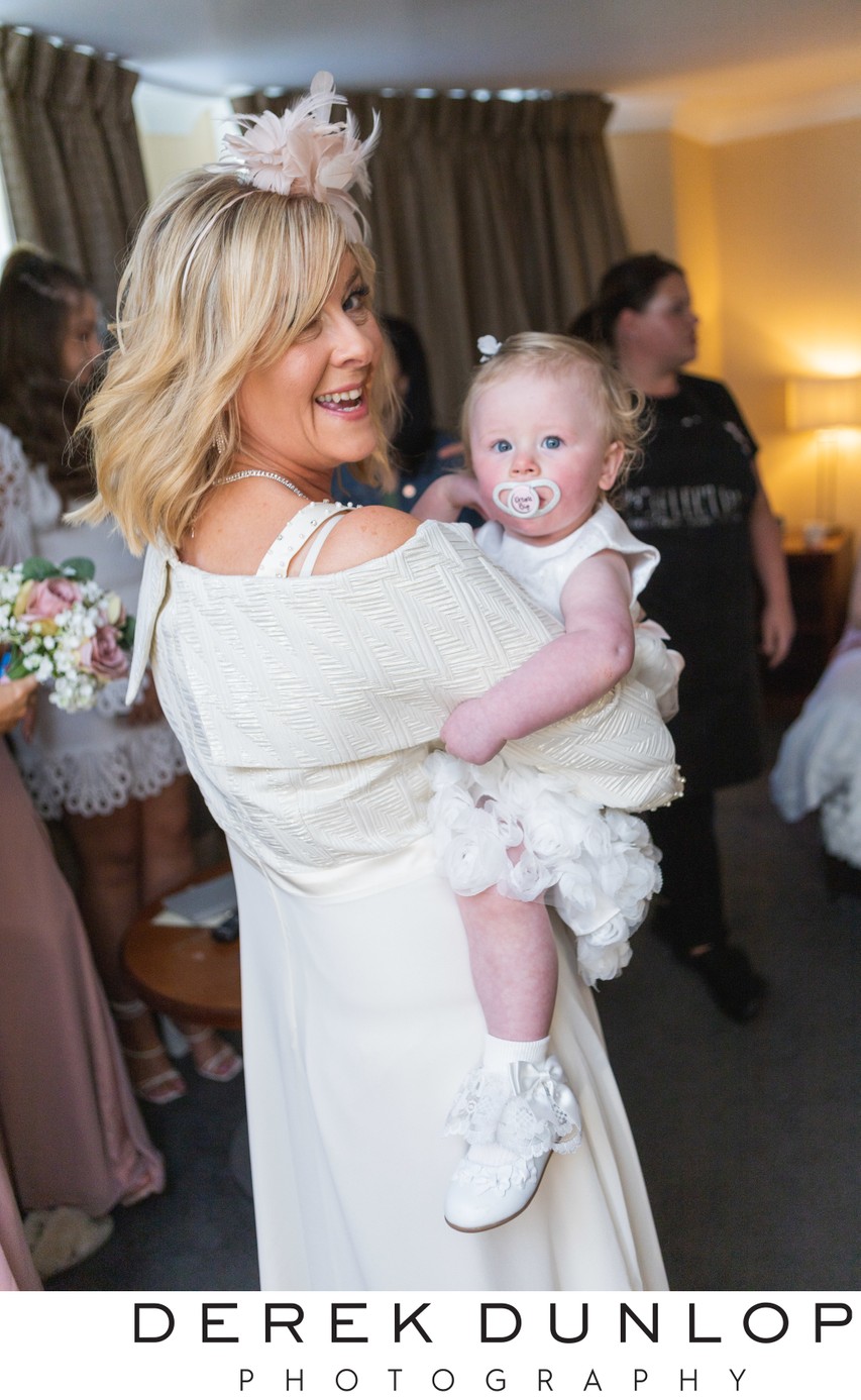 Flower girl cuddle Ross Priory wedding