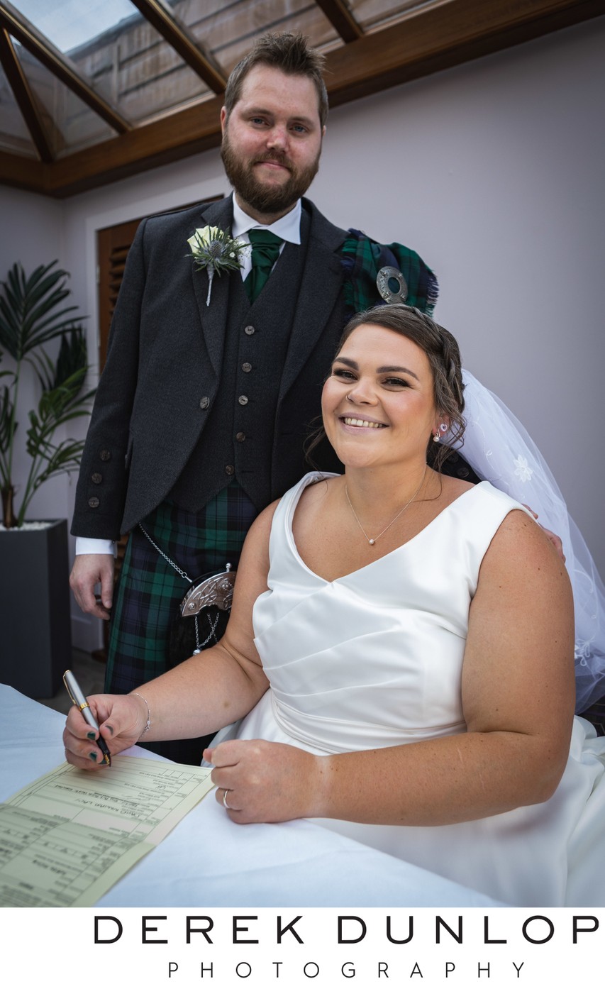 bride and groom signing the register