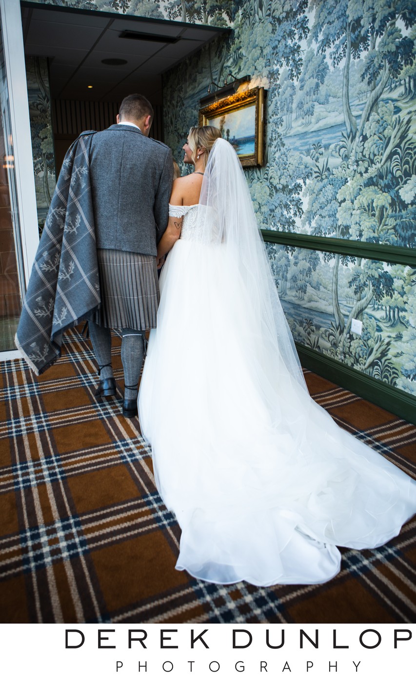 Couple walking tartan carpet Marine Troon