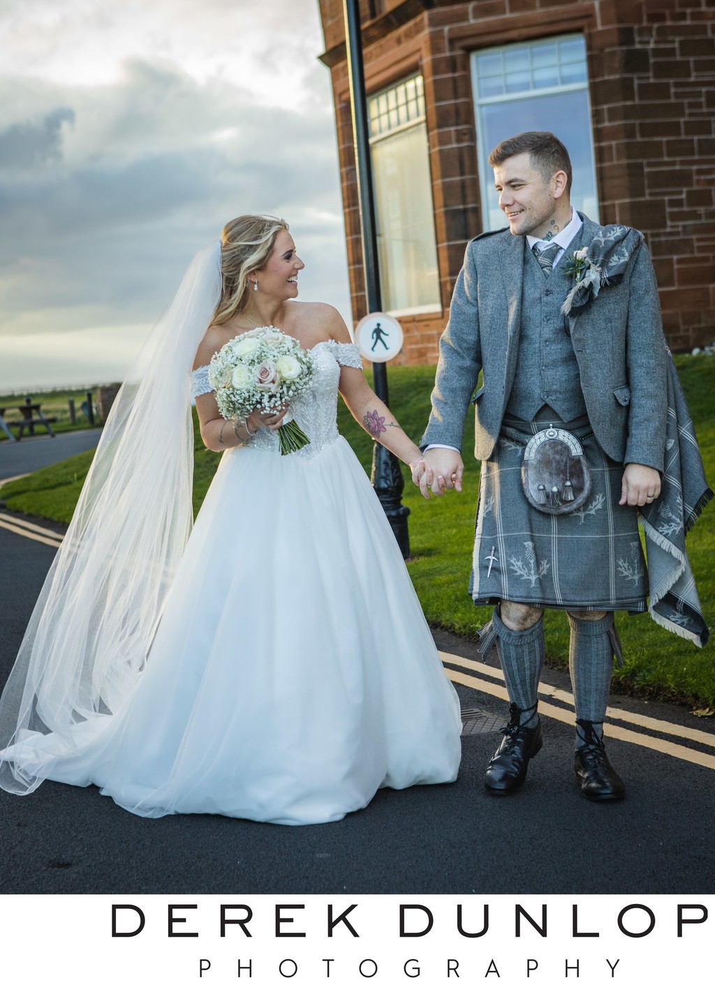 Bride and groom hand in hand Troon