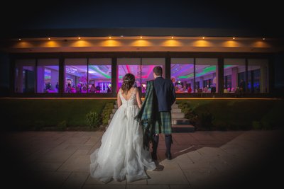 beautiful night photo of lochside with married couple