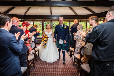 newly married walking down the aisle at Ayrshire wedding venue