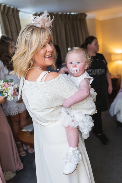 Flower girl cuddle Ross Priory wedding