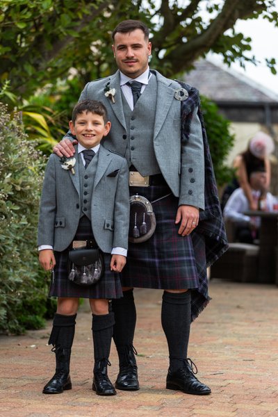 groom and family wedding photo outside at Fairfield house hotel