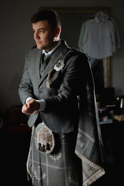 Groom checking watch wedding prep Troon