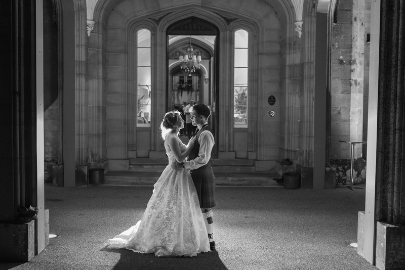 Blairquhan Castle wedding couple portrait at gothic archway evening — Derek Dunlop Photography Ayrshire