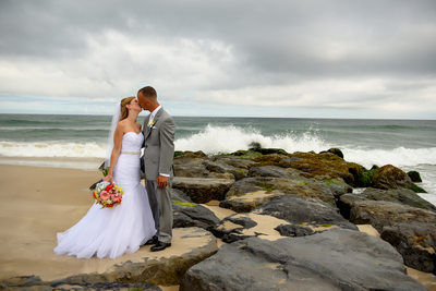 Oceanbleu, Westhampton  bride and groom kiss on the rocks