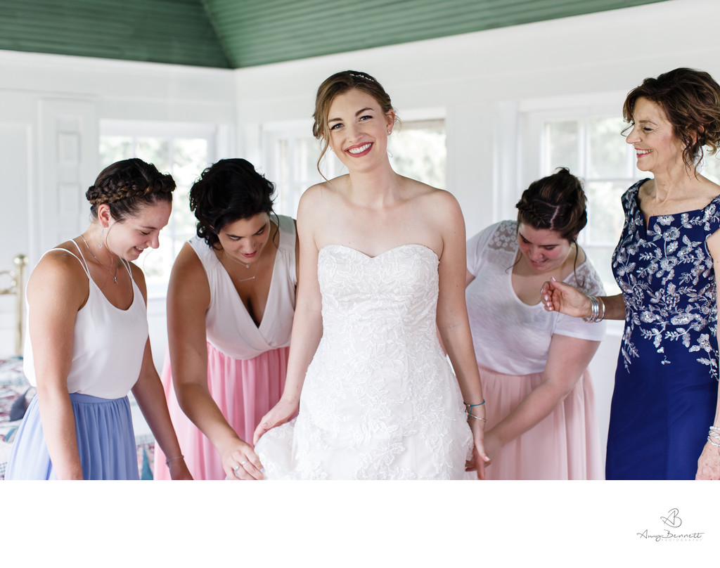 Fussing Bridesmaids with Smiling Bride