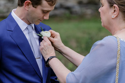 Mother of the Groom Affixes Boutonniere