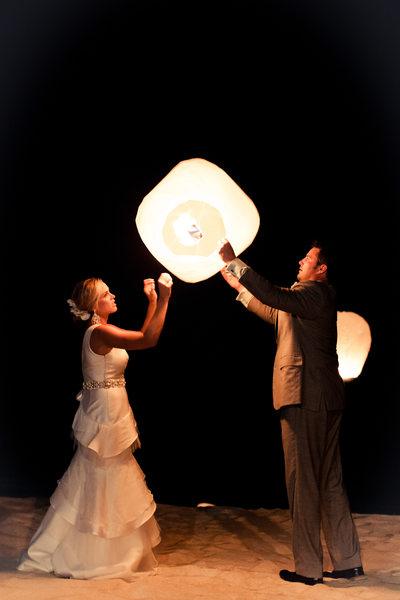 newlyweds holding lanterns
