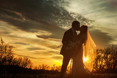 Sunset Wedding Photo of Couple Kissing at Arbor Hills