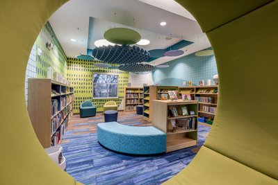 Colorful children's library with green acoustic panels
