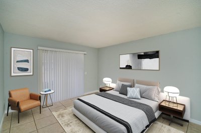 staged bedroom furnishings in a condo