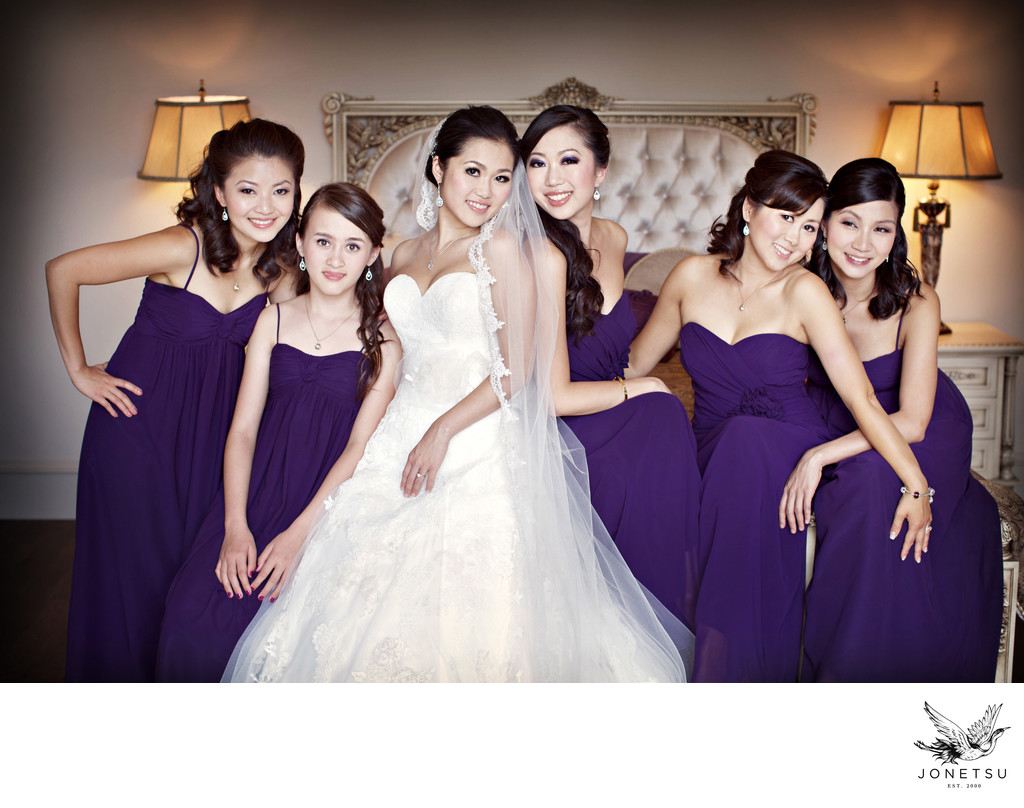 Bride with bridesmaids portrait in the morning on bed