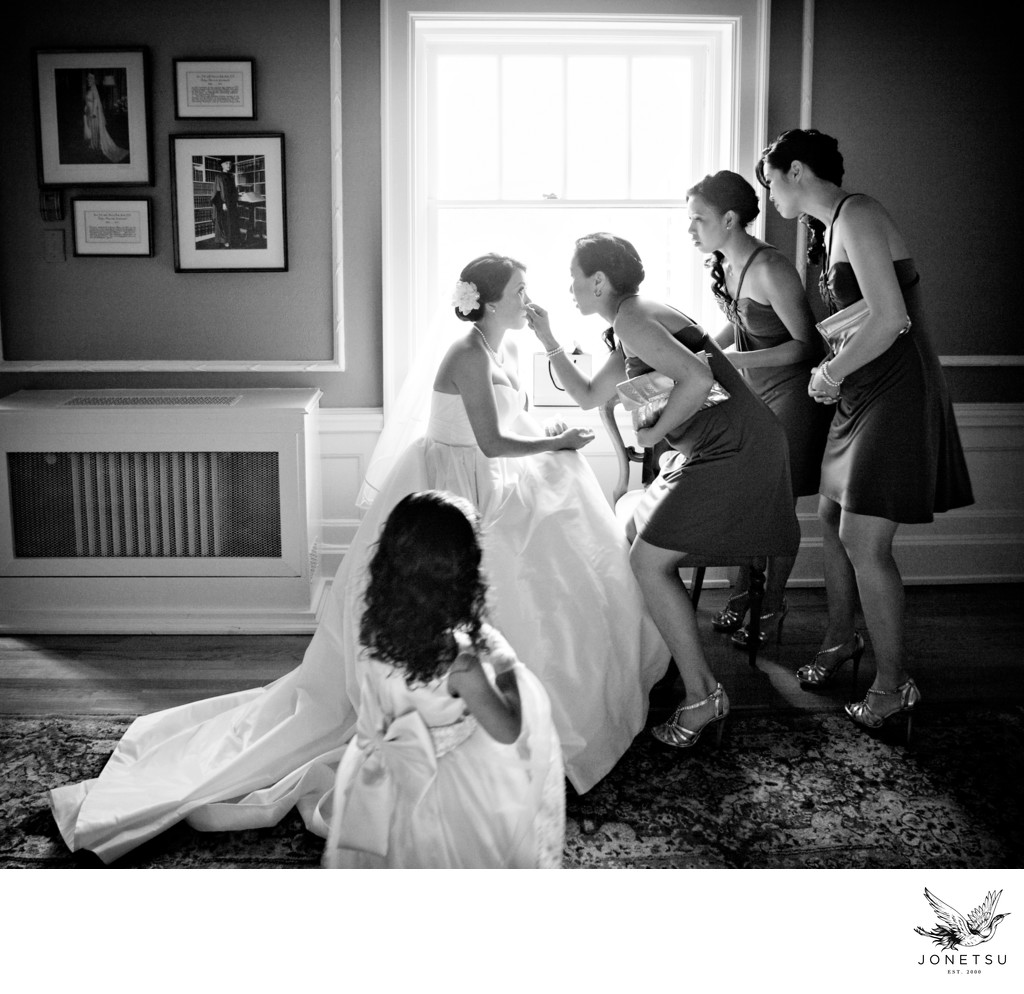Bridesmaids help bride touchup before Hycroft ceremony