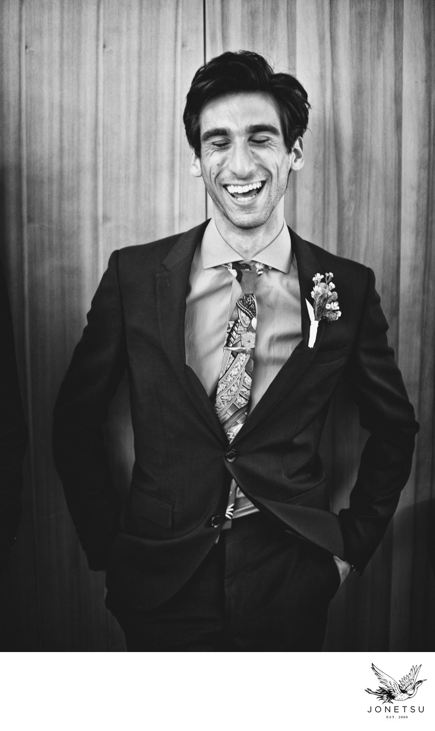 Laughing brother of the bride in black and white