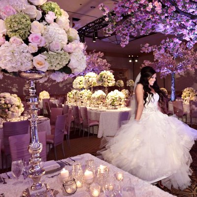 Bride dances under cherry blossom themed wedding decor