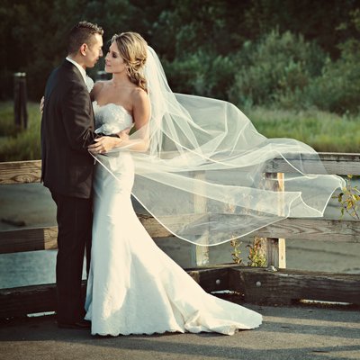 wedding portrait with veil blowing in the wind