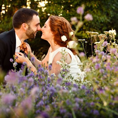 Wildflower romance portrait with happy bride and groom