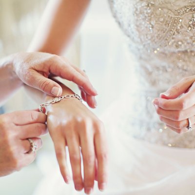 Bride and her mother share a moment and diamonds