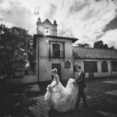 Bride in Lazaro gown in front of church in Bogota
