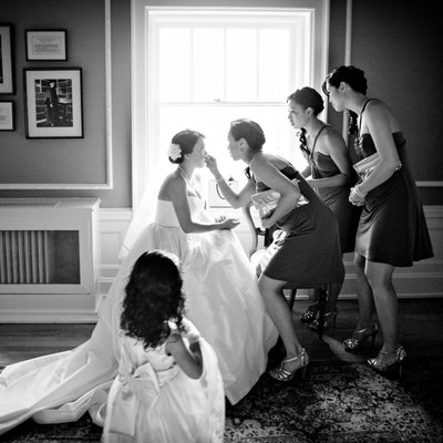 Bridesmaids help bride touchup before Hycroft ceremony