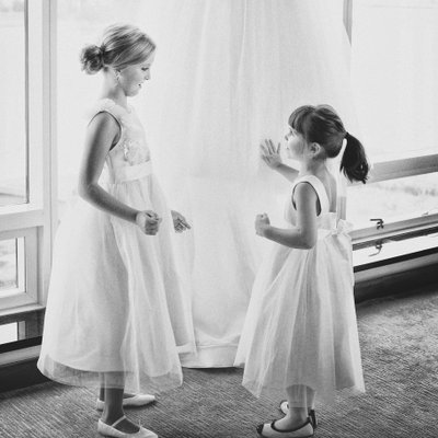 Flower girls touch the bride's Vera Wang gown