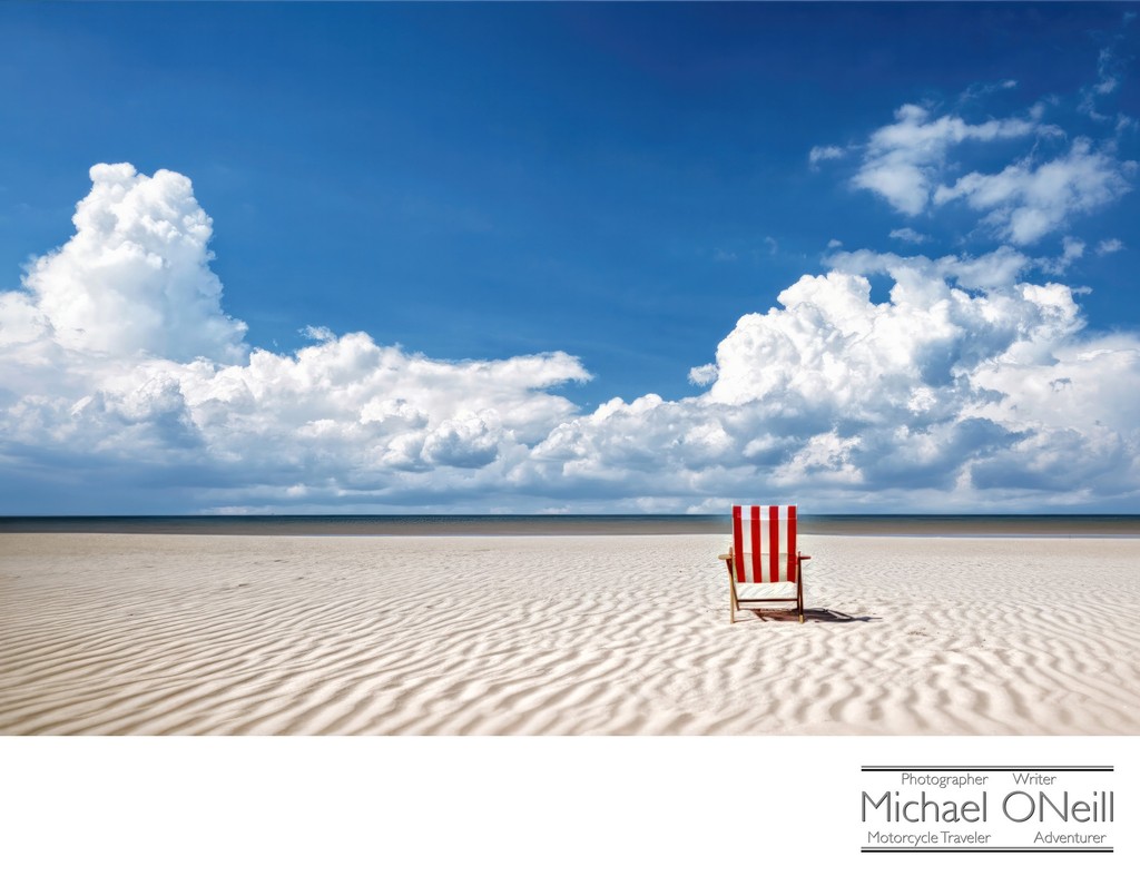 A Lone Beach Chair Sits On The Perfect Beach On An Ideal Day