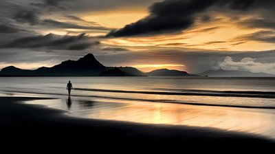Solitude - Man Walking Along Quiet Beach At Dusk