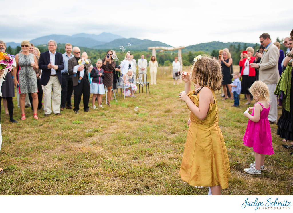Little girl blowing bubbles VT wedding ceremony