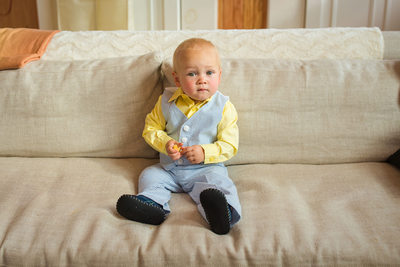 Cute little boy in yellow and blue suit
