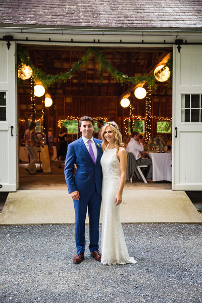 Bride and groom in front of barn West Mountain Inn