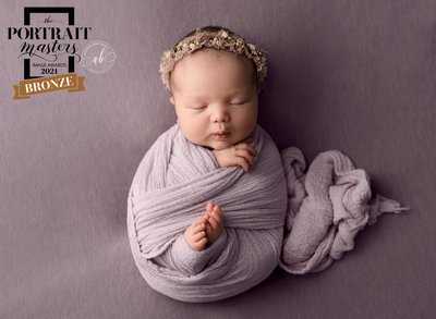 Baby wrapped in lavender with headband 