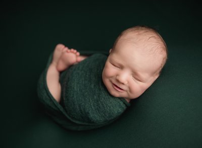 Baby boy wrapped in green