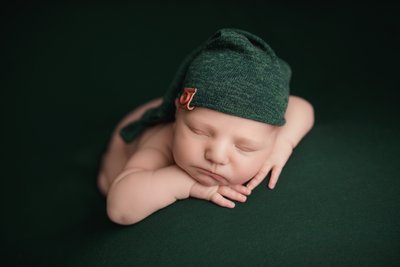 Baby boy in green hat