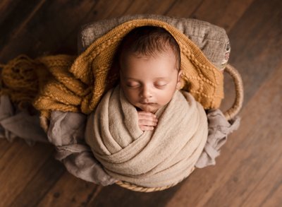 Wrapped baby boy in neutrals
