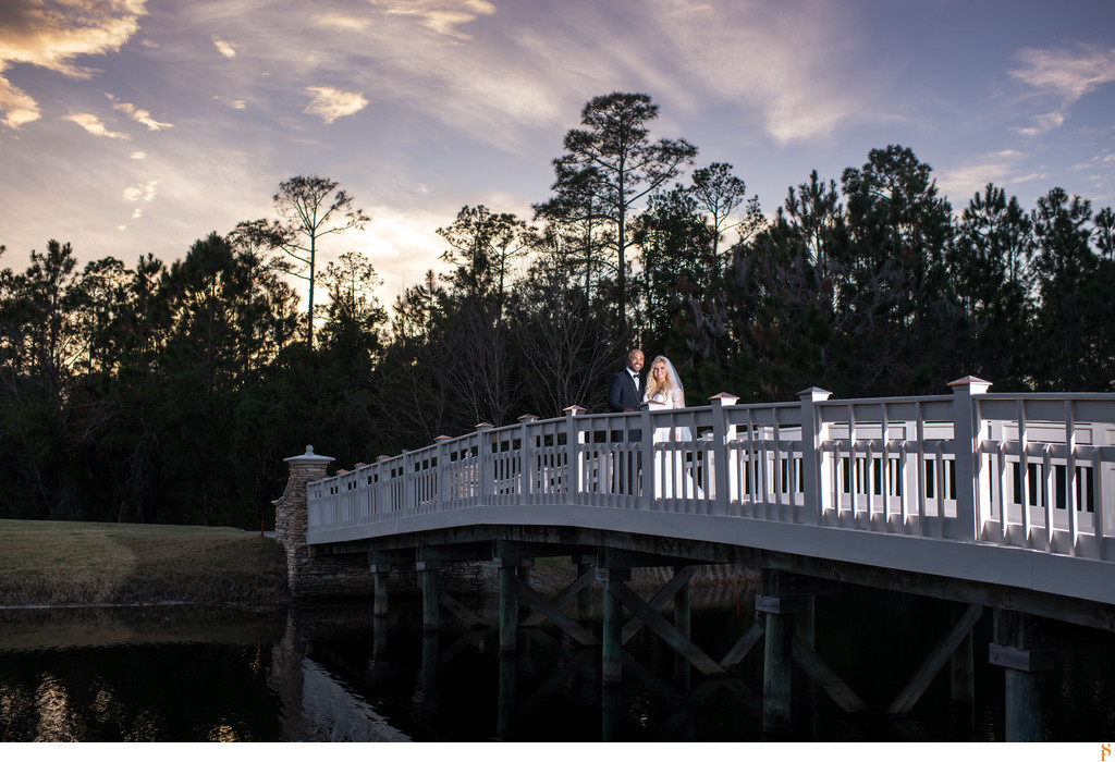 Bride and groom at sunset on a bridge in Nocatee St johns