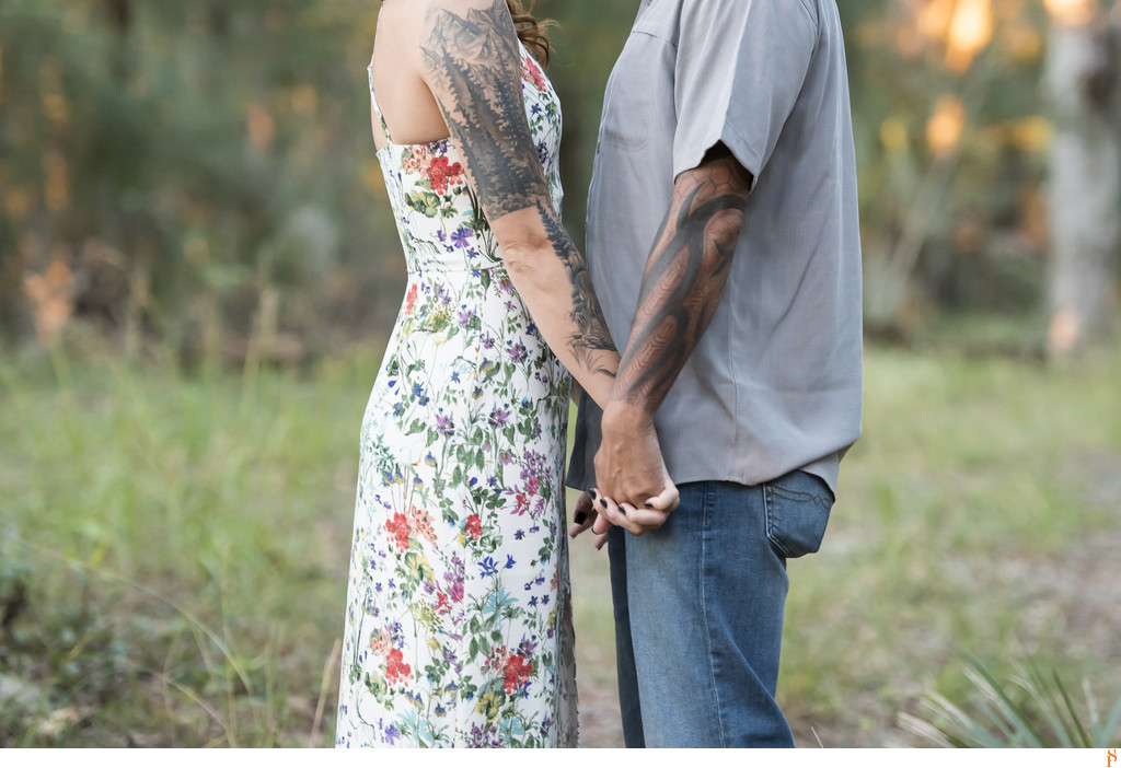 We love how her dress shows her tattoos for their engagement photos.