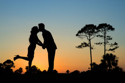 Sunset Engagement Photographs with silhouette and trees