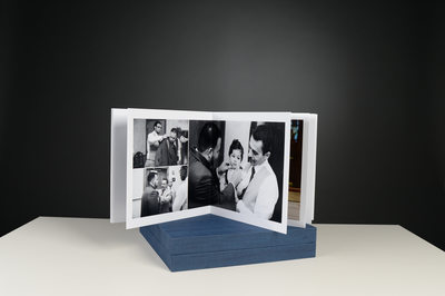 BLACK AND WHITE PHOTOGRAPHS IN A WEDDING ALBUM WITH A BLUE BOX