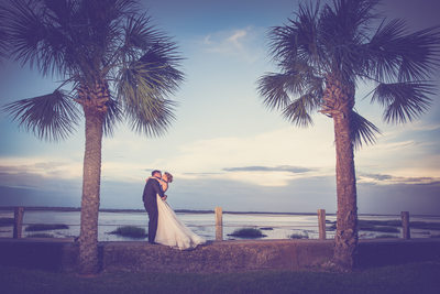 Bride and groom at the beach with palmiers