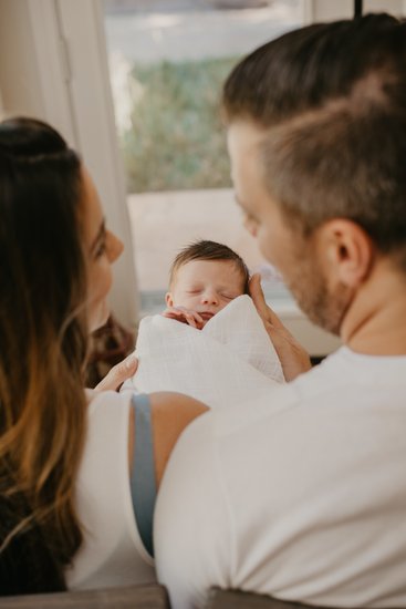 New Parents Holding Their Newborn Sacramento Photoshoot