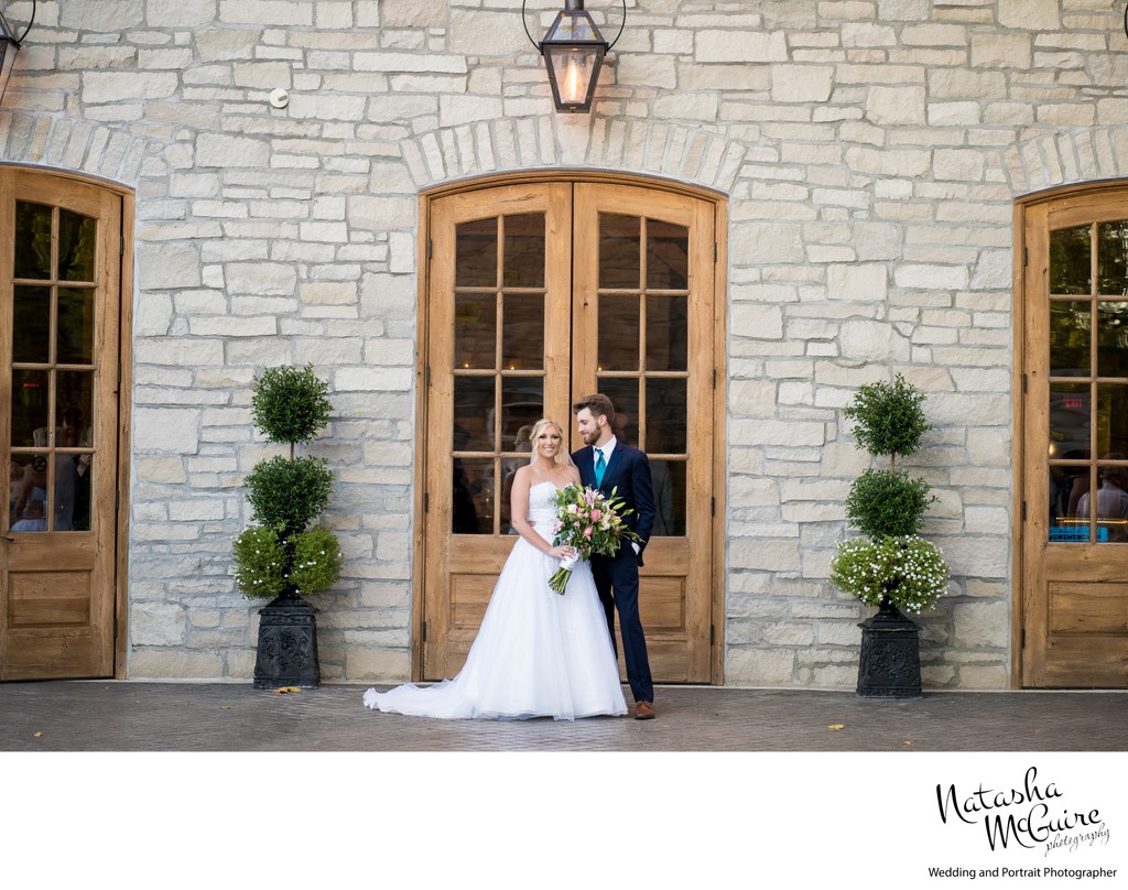 Wedding couple in front of Stone House of St Charles