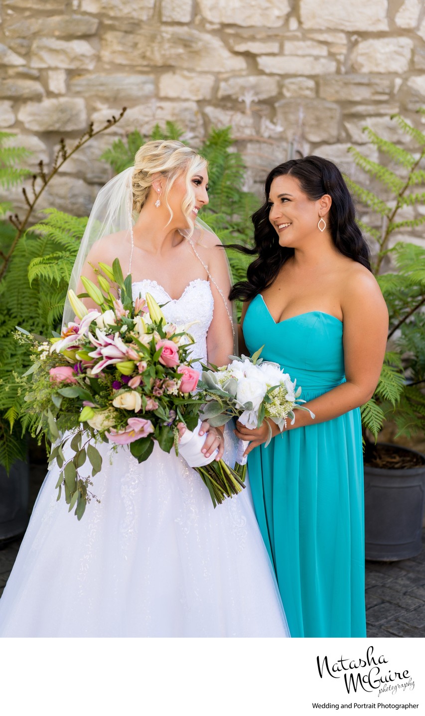 Bride and bridesmaid courtyard Stone House St Charles