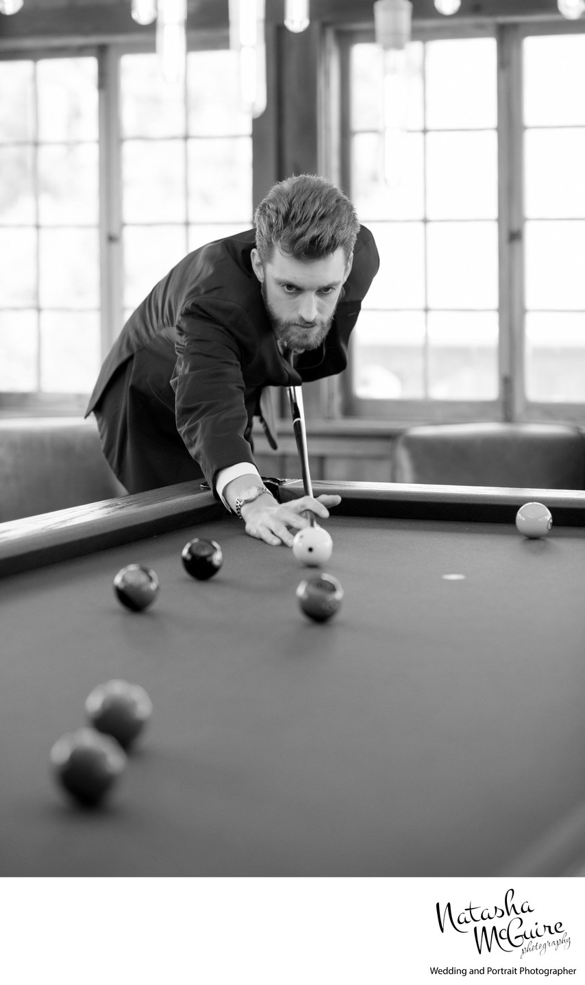 Groom playing pool at Stone House of St Charles