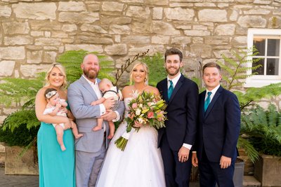 Bride and groom with family at St Charles wedding